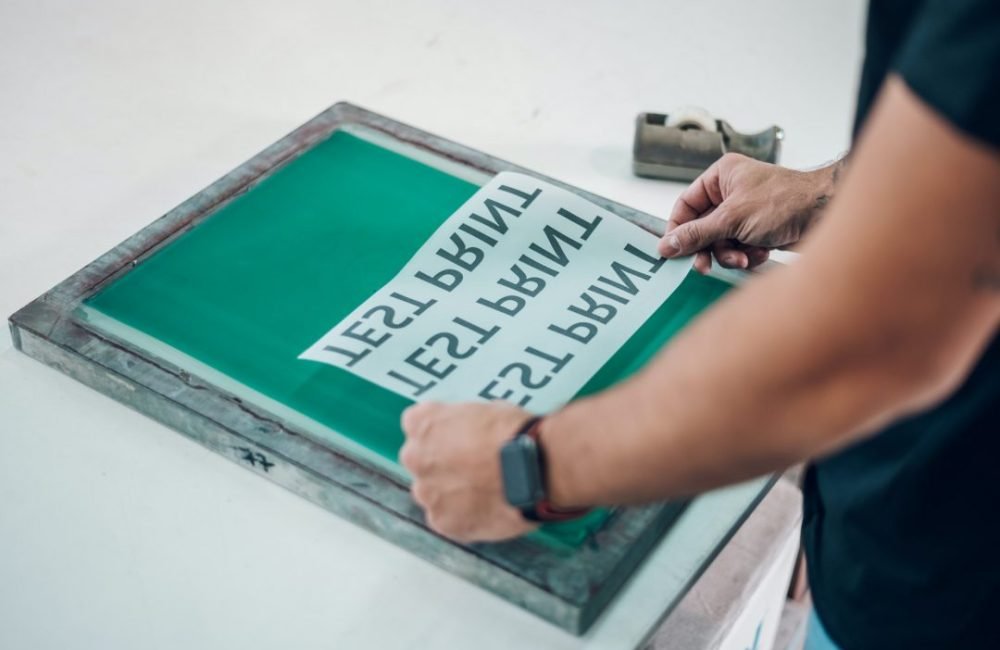 male-worker-preparing-screen-printing-film-in-workshop.jpg